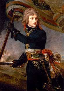 A three-quarter-length depiction of Bonaparte, with black tunic and leather gloves, holding a standard and sword, turning backwards to look at his troops