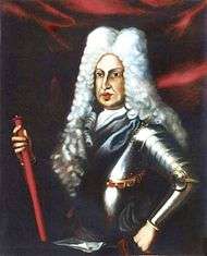 A corpulent man wears a powdered peri-wig with a black set of armour.