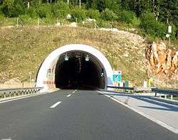 Plasina Tunnel portal with variable traffic signs indicating one way traffic in the tunnel tube, now standard on the A1 motorway.