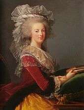 Three-quarter length portrait of a woman holding a book on a green velvet pillow. She is wearing a red and gold velvet dress adorned with a thin, white organza around the bosom and a gray wig, also adorned by thin, white material.