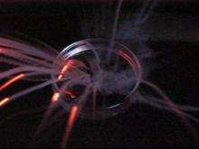 A person adds a small amount of metal to a petri dish with cold water which produces a small explosion.