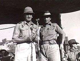 Three-quarter informal portrait of two men in tropical military uniform