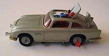 a silver-coloured toy car showing a plastic man being ejected through the roof.