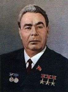 A man with wavy dark graying hair in a suit, with three Hero of the Soviet Union stars pinned on it