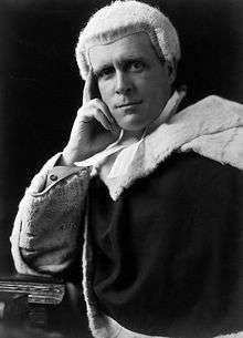 Formal photo of a judge in wig and robe
