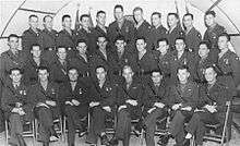 A large group of men in military uniforms pose for a photograph