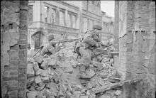 two men in a rubble strewn street