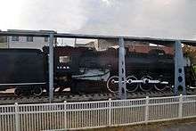 A sideview of a black locomotive