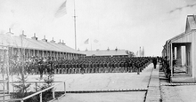 black and white photo of assembled regiment, Riker's Island