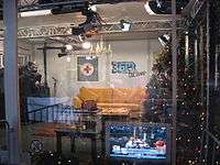 Studio with Christmas tree and golden-yellow couch