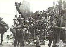 Soldiers disembarking from a landing craft