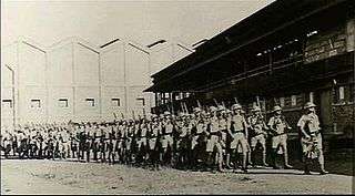 A group of soldiers marching in column of route