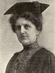 Ann Allebach photo portrait wearing a black gown and mortarboard