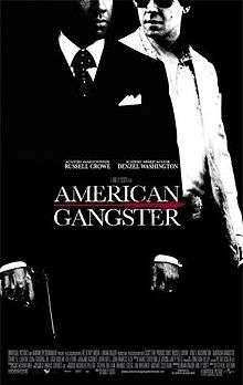 A black-and-white picture, depicting Frank Lucas in a black suit and Richie Roberts in a white one. In front of them is the title American Gangster, with Russell Crowe and Denzel Washington's names above, and the film credits below.