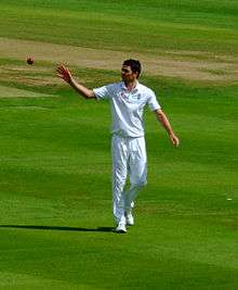 A photograph of James Anderson bowling against Australia in August 2009