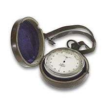 A small circular pocket-watch sized instrument in a leather case