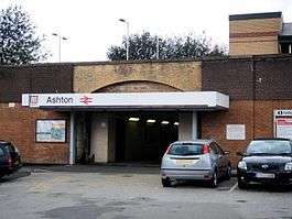 The entrance to a train station with a sign saying "Ashton" above the entrance