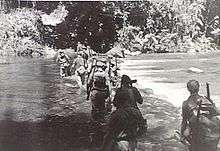 Soldiers crossing a river