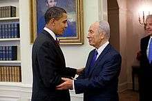 President Barack Obama, at left, shakes hands with Israeli President Shimon Peres, at right, in the Oval Office on Tuesday, May 5, 2009. Standing at right looking on is U.S. Vice President Joe Biden.