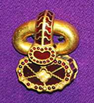 A golden object decorated with small gems