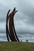 Large curved metal sculpture by Bernar Venet