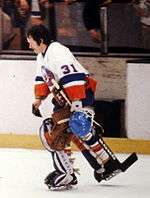 Billy Smith skating with the Islanders with his goaltender mask off.