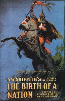The theatrical poster for The Birth of a Nation depicting a hooded man carrying a burning cross on horse back.