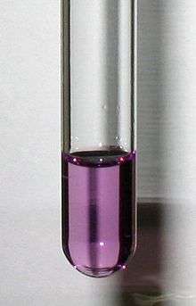 A test tube containing a clear violet solution
