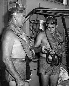 This is a photo of Commander George F. Bond and Chief Engineman Cyril Tuckfield after safely completing a 302-foot buoyant ascent in 52 seconds from the forward escape trunk of  USS Archerfish bottomed at 322 feet.