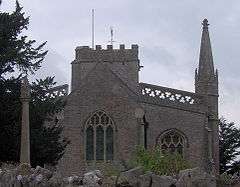 Stone building with arched windows and a square tower.