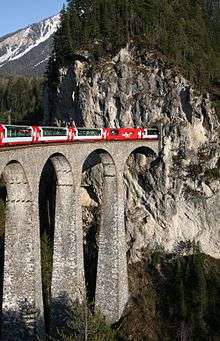 Rhaetian Railway Glacier Express on the Landwasser Viaduct entering the Landwasser tunnel.