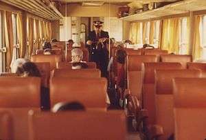 A conductor collects tickets aboard a Midwestern Turboliner in 1974