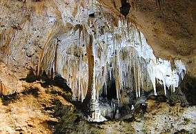 Column and array of stalactites in a cave.