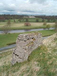 View of the ruins of Roxburgh castle, open country with the River Tweed and, in the distance, Floors Castle.