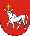 A coat of arms depicting a white bull with an angry expression and a golden cross protruding from its head all on a red background