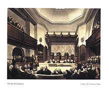 A drawing of the Court of Common Pleas, created in the early 1800s. Three Justices in black robes stand on podiums in the middle of the room, hearing a case. Around the outside of the room, the public is listening in on the case.