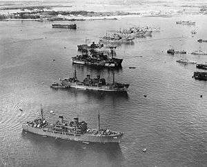 Aerial photo of target ships anchored in a row at Pearl Harbor, Hawaii.