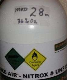 A white plastic adhesive label on a cylinder labeled for Enriched air-Nitrox. There is a smaller label above it on the shoulder indicating the mix proportions - 36% Oxygen, and the Maximum operating depth - 28m