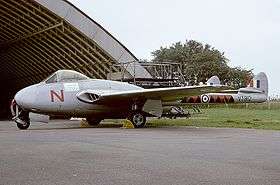 Single-seat twin-tailboom jet aircraft parked at airfield