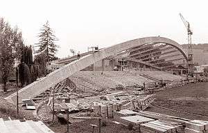 Black and white photograph of a football stand under construction.