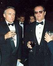 Dennis Hopper and Jack Nicholson wearing tuxedos and holding drinks