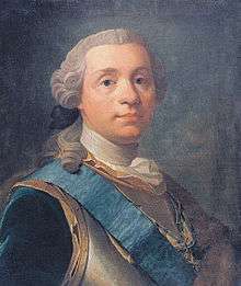 A man in his mid-40s wearing a powdered 18th-century style wig. He has a calm composure and is looking directly at the viewer. He is wearing a cuirass (body armor) adorned with a blue silk band with a dark blue coat underneath. Around his neck hangs an order or medal in the form of a Maltese cross with a royal crown over it, attached to a blue and yellow ribbon.
