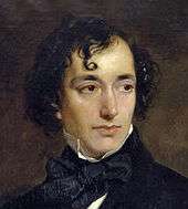 A young man of vaguely Semitic appearance, with long and curly black hair