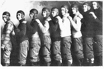 members of a football team wearing old-fashioned leather helmets