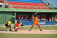 Rentería holding a bat over his shoulder while wearing an orange uniform.