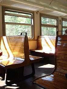 Inside of old train, with wooden seats