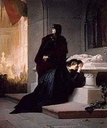 Young woman crying at a tomb with her mother standing above her