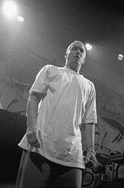 Eminem onstage in a white T-shirt