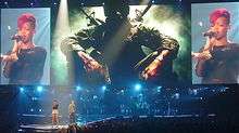 Eminem and Rihanna onstage in front of three large theater screens
