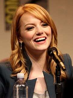 A picture of Emma Stone as she smiles away from the camera.